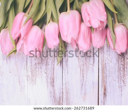 Pink tulips over shabby white wooden table, vintage retro style