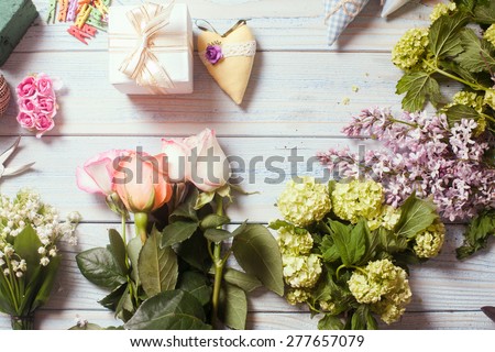 Preparation of flower bouquet, top view of florist workplace with copy space