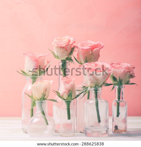 Pink roses in vintage bottles, home decor
