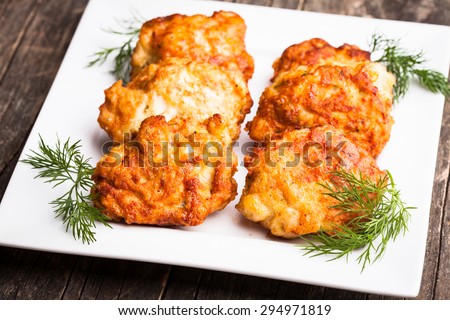 Chicken cutlets with dill in a white plate on the table