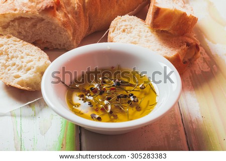 Ciabatta - italian bread with olive oil and spices over wooden table