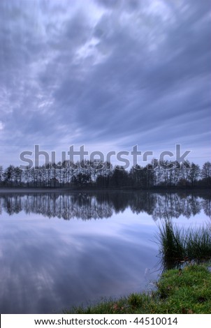 Sundown on lake in autumn, slouds on the sky after rain  and fog, hdr