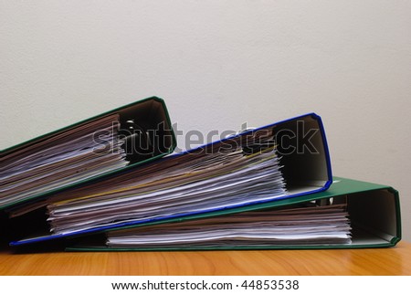 Stack of documents in folders on office desktop close-up. Shallow deep of field