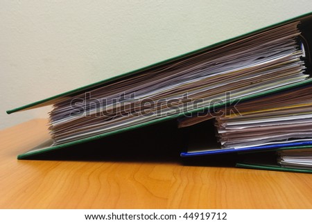 Stack of documents in folders on office desktop close-up. Shallow deep of field