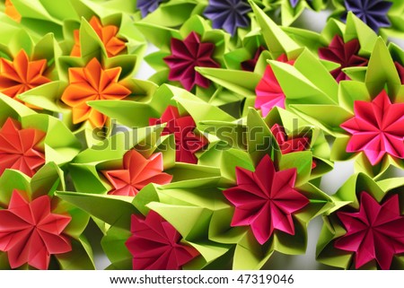 Origami bunch of various rainbow flowers isolated on white