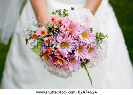 The bride with a wedding bouquet close up outdoor. Shallow deep of field
