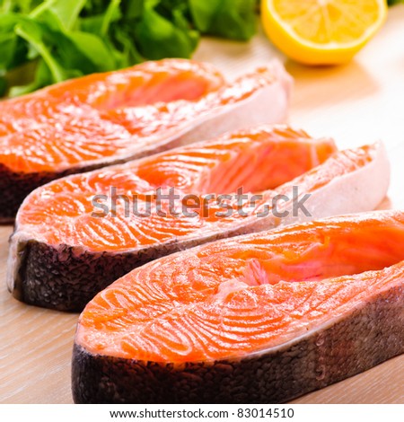 Raw salmon steak in row, prepared for cooking