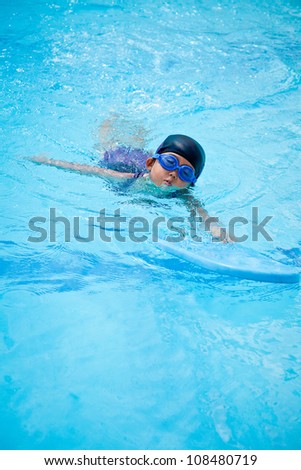 small girl swimming in the pool