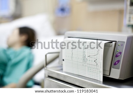 patient in hospital with medical test print out