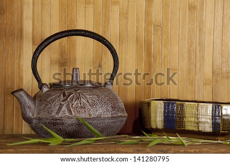 Red Japanese tea serving dish and bamboo.