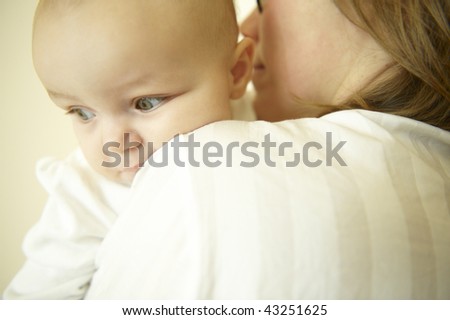 Mom holding baby. Horizontally framed shot.