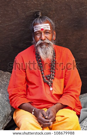 HAMPI, INDIA - JULY 26: Sadhu sitting in the cave at July 26, 2012 in Hampi, India. Sadhus are holy men who have chosen to live an ascetic life and focus on the spiritual practice of Hinduism.