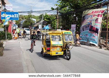 BORACAY, PHILIPPINES - MARCH 04: Tricycle on the street, March 04, 2013, Boracay, Philippines. Motorized tricycles are a common means of passenger transport everywhere in the Philippines.