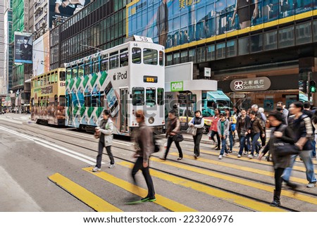 HONG KONG - FEBRUARY 21: Unidentified people crossing the street on February 21, 2013 in Hong Kong. With a 7 million people, Hong Kong is one of the most densely populated areas in the world.