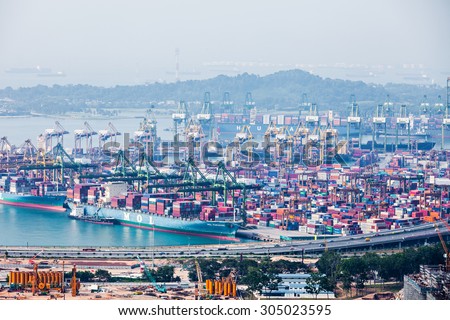 SINGAPORE - OCTOBER 18, 2014: The port of Singapore. It\'s the world\'s busiest transshipment port and the world\'s second busiest port in terms \
of total shipping tonnage.