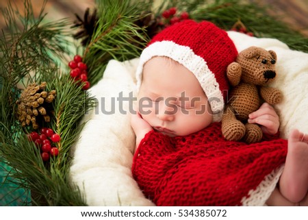 baby sleeps in a basket in Christmas costumes