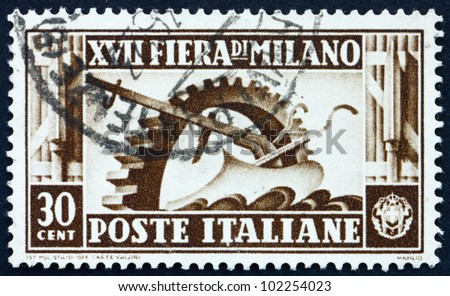 ITALY - CIRCA 1936: a stamp printed in the Italy shows Cogwheel and Plow, 17th Milan Trade Fair, circa 1936