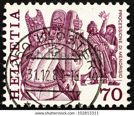 SWITZERLAND - CIRCA 1977: a stamp printed in the Switzerland shows Procession, Horse and Masked Men, Mendrisio, Folk Customs, circa 1977