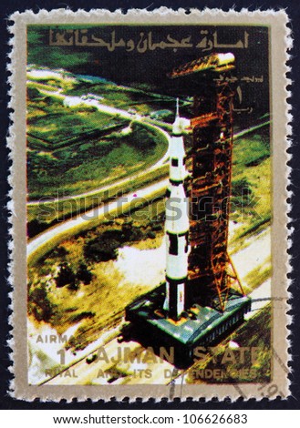 AJMAN - CIRCA 1973: a stamp printed in the Ajman shows Roll out of Saturn 5 on launch pad, Moon-landing, Apollo 11, circa 1973