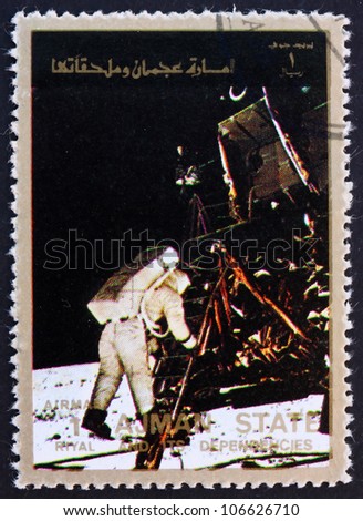 AJMAN - CIRCA 1973: a stamp printed in the Ajman shows Edwin Buzz Aldrin Stepping out of the Eagle, Moon-landing, Apollo 11, circa 1973