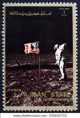 AJMAN - CIRCA 1973: a stamp printed in the Ajman shows Edwin Buzz Aldrin Salutes U.S. Flag on the Lunar Surface, Moon-landing, Apollo 11, circa 1973