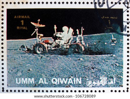 UMM AL-QUWAIN - CIRCA 1972: a stamp printed in the Umm al-Quwain shows Astronaut Driving a Moon Rover, Moon-landing, Apollo, circa 1972