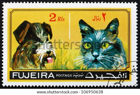 FUJEIRA - CIRCA 1971: a stamp printed in the Fujeira shows Dog and Cat, Pets, circa 1971