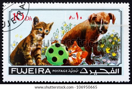 FUJEIRA - CIRCA 1971: a stamp printed in the Fujeira shows Dog and Cat, Pets, circa 1971