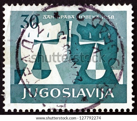 YUGOSLAVIA - CIRCA 1958: a stamp printed in the Yugoslavia shows White and Black Hands Holding Scales, 10th Anniversary of Universal Declaration of Human Rights, circa 1958