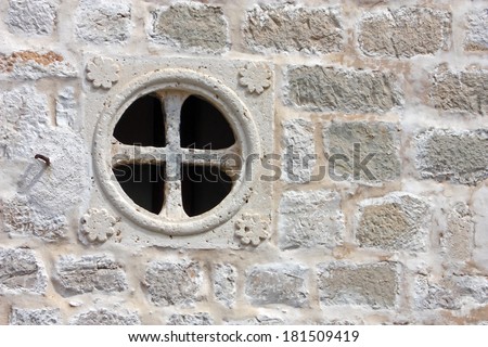 Round window without casements on the stone wall