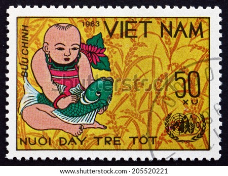 VIETNAM - CIRCA 1983: a stamp printed in Vietnam shows Infant and Fish, World Food Day, circa 1983