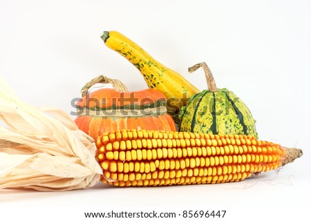 Three colorful gourds with maize, isolated