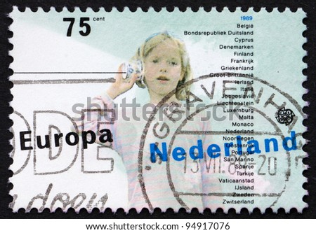 NETHERLANDS - CIRCA 1989: a stamp printed in the Netherlands shows Girl and String Telephone, Children\'s Games, circa 1989