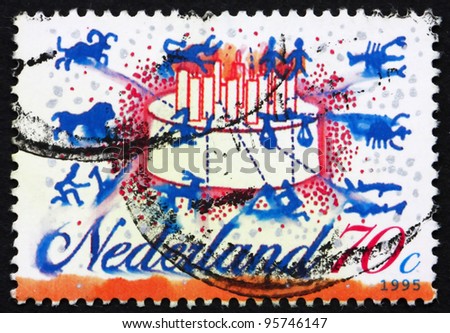 NETHERLANDS - CIRCA 1995: a stamp printed in the Netherlands shows Signs of the Zodiac, Birthday Cake, circa 1995