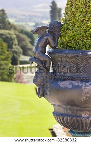 Powerscourt Mansion in county Wicklow, Ireland. View over the gardens and a beautiful flower vase decorated with angels.