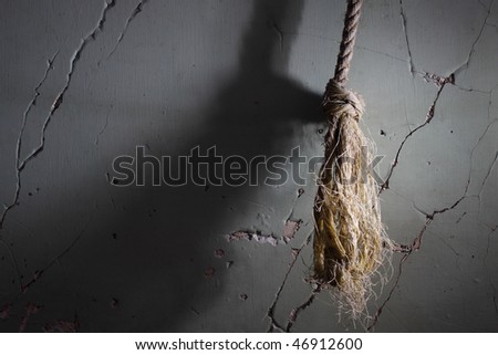 old rope hanging in old abandoned building, side lit with strobe