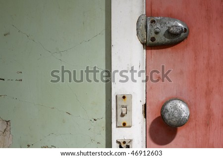 door,door handle,lock and light switch in old abandoned building, lit with strobe