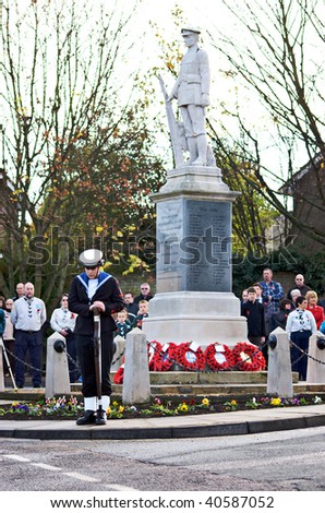 MILDENHALL, UK - NOVEMBER 8: Royal Navy Sea Cadet standing guard at the war memorial during the remembrance sunday parade and ceremony on November 8, 2009 in Mildenhall, UK.