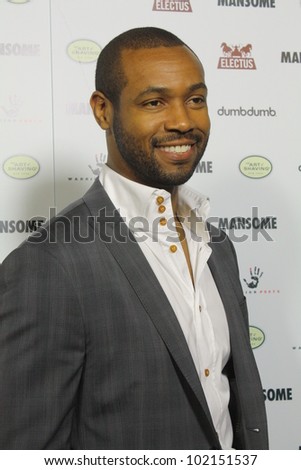 HOLLYWOOD - MAY 9, 2012: Old Spice guy Isaiah Mustafa walks the red carpet for the premiere of Mansome held at the Arclight Theatre May 9, 2012 Hollywood, CA.