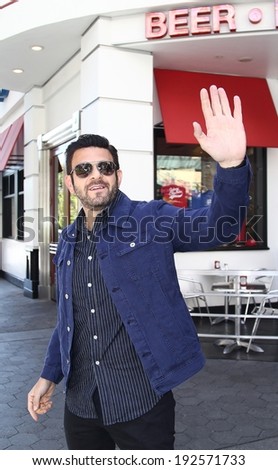 UNIVERSAL CITY CA- MAY 12, 2014: Man vs Food host Adam Richman comes to Universal Studios Hollywood for an appearance on Extra May 12, 2014 Universal City CA