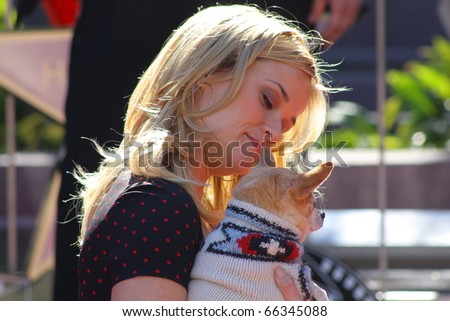 HOLLYWOOD - DECEMBER 1: Actress Reese Witherspoon and Bruiser the Chihuahua celebrating her star on the Hollywood Walk of Fame December 1, 2010 in Hollywood, CA.