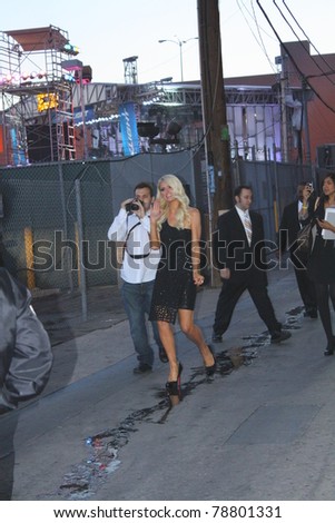 HOLLYWOOD - JUNE 7: Socialite/reality tv star Paris Hilton walking over to sign autographs after her appearance of the Jimmy Kimmel show outside the Jimmy Kimmel Studios June 7, 2011 Hollywood, CA.