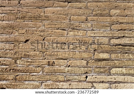 Detail of the many graffiti on one wall inside the Flavian Amphitheatre in Rome, Italy