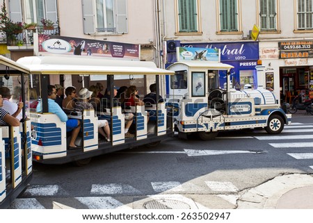 CANNES, FRANCE - SEPTEMBER 8, 2014: The little train of Cannes travels through the narrow streets of the old town of Cannes and it is a good way of having a quick view of the city.