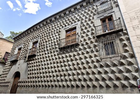 SEGOVIA, SPAIN - SEPTEMBER 14, 2014: Casa de los Picos with its facade covered by granite blocks carved into diamond-shapes in Segovia, Spain.