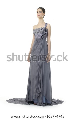 Beautiful young woman dressed in evening gown isolated over white background