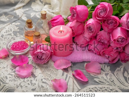 Pink rose petals and rose with candle ,salt in bowl,towel on lace