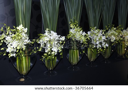 Row of bouquet white orchid and long leaf