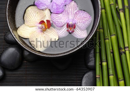 bowl of orchid and stones on bamboo stick straw mat