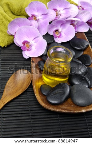 spa concept (zen stones, massage oil , towel and orchid ,zen stones ,spoon)